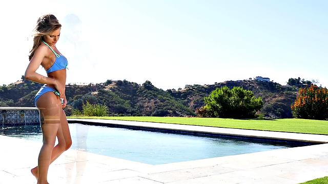 Blonde with natural tits enjoys solo outdoor pool play with piercing and tits out