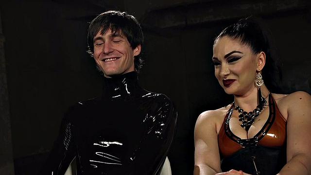 Whipping latex domina pegs sub in suspension bondage