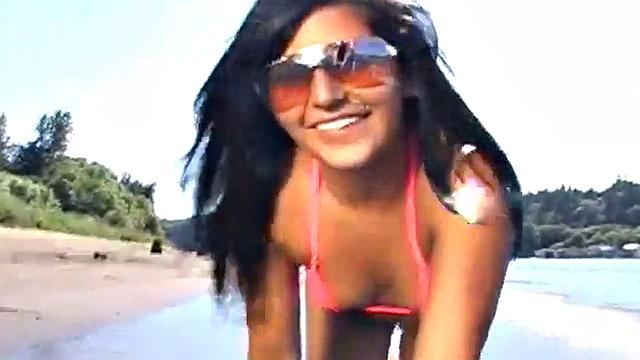 Gorgeous petite teen teases at the beach
