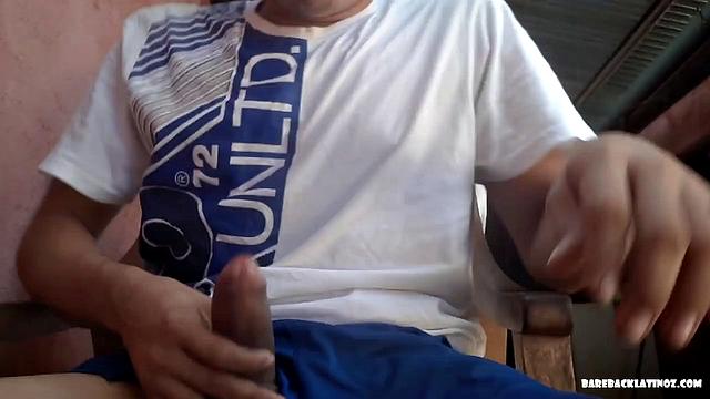 Latin boy Arthur seated in chair, pulling out fat uncut cock from shorts to play with. By the time big dick is hard, young man is naked and ready to beat off.