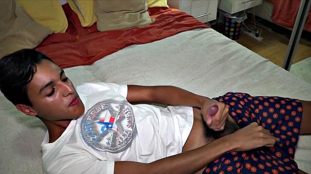 Our featured solo boy of the week is Latin twink Agus, who is kicked back on his bed and ready to play. He pushes his shorts down just enough to grab cock and starts working up a boner.