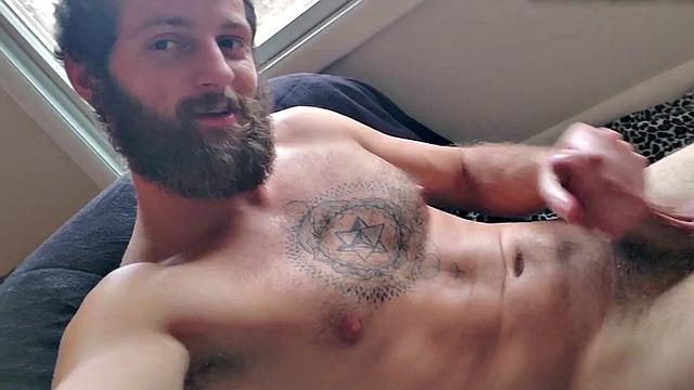 Tattooed otter tugs his dick for cumshot