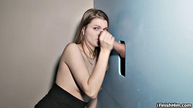 Inked gloryhole lover jerks and sucks through blue wall
