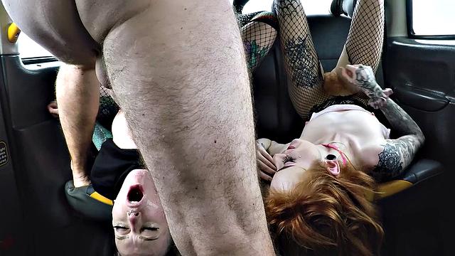 Redhead in taxi enjoys hardcore threesome with dildo, handjob, and pussy fisting
