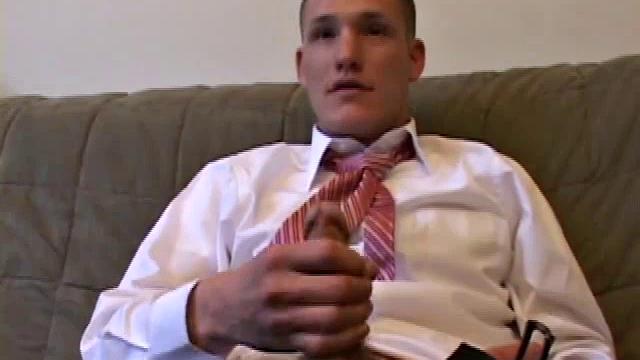 Jay unzips pants, pulls out raging boner and strokes to porn video. After stripping off shirt and tie, Jay works dick as he talks to camera. In no time he explodes a killer cum gusher on his face and chest.