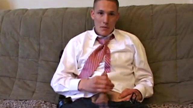 Jay unzips pants, pulls out raging boner and strokes to porn video. After stripping off shirt and tie, Jay works dick as he talks to camera. In no time he explodes a killer cum gusher on his face and chest.