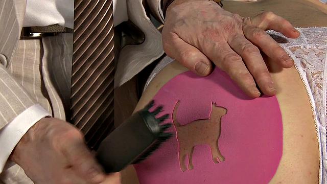 BDSM dom spanks brand onto his subject