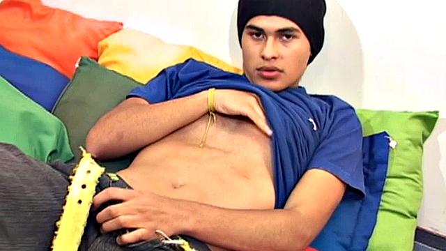 This cute and silky smooth Latin boy is packing a big one, which is obvious when he pushes his pants down. Alfredo pulls out that monster uncut cock and starts stroking.