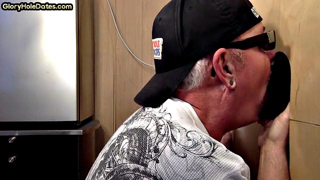 Gloryhole gay sucks big black cock while stroking