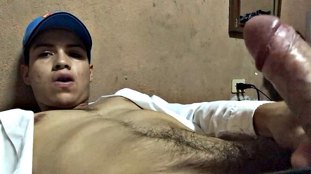 Our featured solo boy of the week is Latino Dantty Calderon. On his bed, he works up a stiff one and then lets his cock pop out of the waist band of his boxers.