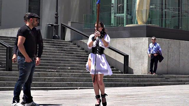 Public BDSM babe deepthroats hard cock in front of onlookers