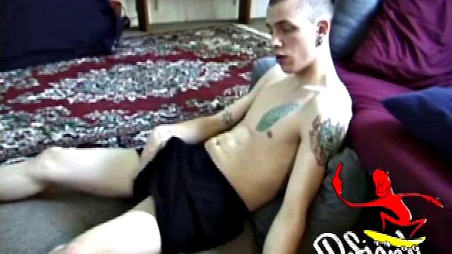 Stripped naked, young Shane relaxes in front of the TV and watches a porno while he beats off. The young man is nice enough to deliver a stroke show, before pumping out his load of warm cum.