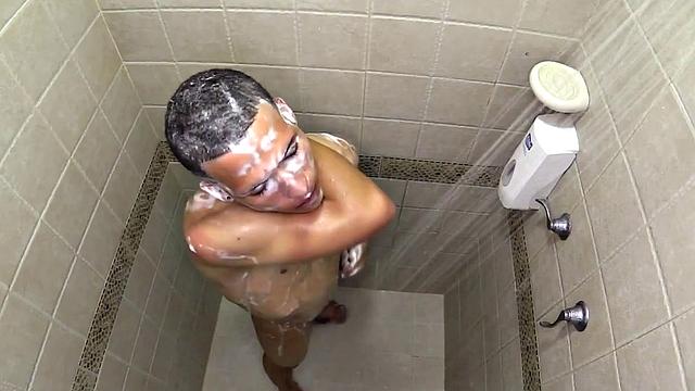 Macho is a smooth Latin boy, already naked, taking a shower. He starts playing with his big dick and in no time he's sporting a boner. He sits on the shower floor and a long stroke show follows.