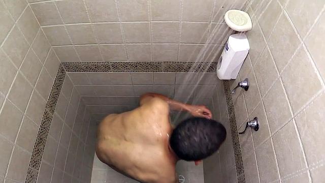 Macho is a smooth Latin boy, already naked, taking a shower. He starts playing with his big dick and in no time he's sporting a boner. He sits on the shower floor and a long stroke show follows.
