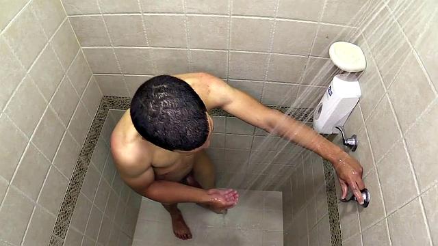 Macho is a smooth Latin boy, already naked, taking a shower. He starts playing with his big dick and in no time he's sporting a boner. He sits on the shower floor and a long stroke show follows.