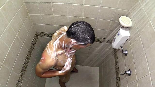 Macho is a smooth Latin boy, already naked, taking a shower. He starts playing with his big dick and in no time he's sporting a boner. He sits on the shower floor and a long stroke show follows.
