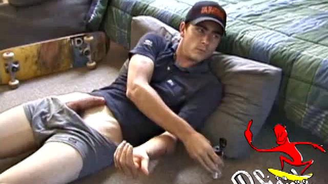 Dan gets down on the floor and starts watching a porn video. He goes right for his cock and plays with himself until he's boned up. Rolling the head with his palm, Dan lubes up his hot dick.