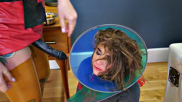 BDSM slut gags on strapon