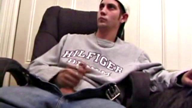 As a porn flick plays, young amateur Aaron Michaels strokes hard, pulls his cock out of his jeans, lets loose, and spills his nut on the bed.