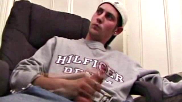 As a porn flick plays, young amateur Aaron Michaels strokes hard, pulls his cock out of his jeans, lets loose, and spills his nut on the bed.