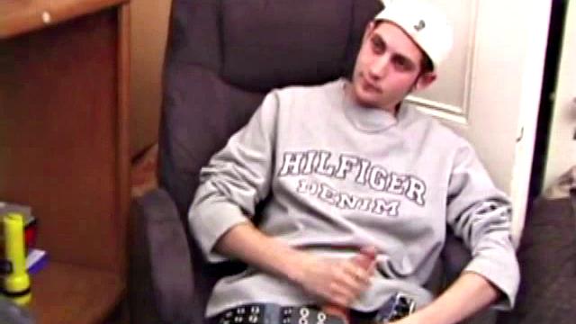 As a porn flick plays, young amateur Aaron Michaels strokes hard, pulls his cock out of his jeans, lets loose, and spills his nut on the bed.