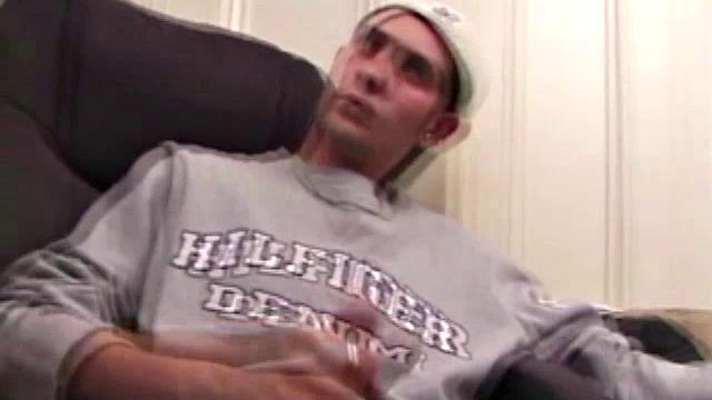 As a porn flick plays, young amateur Aaron Michaels strokes hard, pulls his cock out of his jeans, lets loose, and spills his nut on the bed.