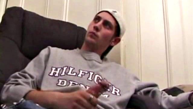 As a porn flick plays, young amateur Aaron Michaels strokes hard, pulls his cock out of his jeans, lets loose, and spills his nut on the bed.