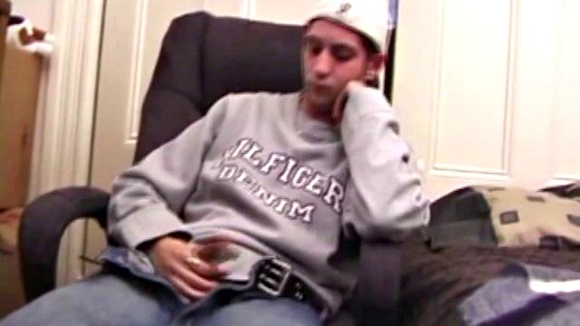 As a porn flick plays, young amateur Aaron Michaels strokes hard, pulls his cock out of his jeans, lets loose, and spills his nut on the bed.