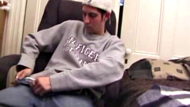 As a porn flick plays, young amateur Aaron Michaels strokes hard, pulls his cock out of his jeans, lets loose, and spills his nut on the bed.