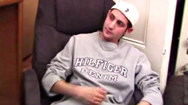 As a porn flick plays, young amateur Aaron Michaels strokes hard, pulls his cock out of his jeans, lets loose, and spills his nut on the bed.