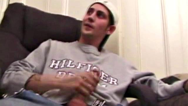 As a porn flick plays, young amateur Aaron Michaels strokes hard, pulls his cock out of his jeans, lets loose, and spills his nut on the bed.