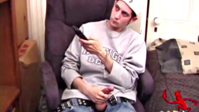 As a porn flick plays, young amateur Aaron Michaels strokes hard, pulls his cock out of his jeans, lets loose, and spills his nut on the bed.