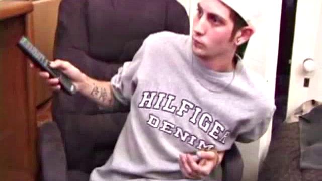 As a porn flick plays, young amateur Aaron Michaels strokes hard, pulls his cock out of his jeans, lets loose, and spills his nut on the bed.