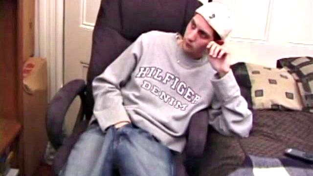 As a porn flick plays, young amateur Aaron Michaels strokes hard, pulls his cock out of his jeans, lets loose, and spills his nut on the bed.