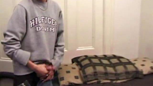 As a porn flick plays, young amateur Aaron Michaels strokes hard, pulls his cock out of his jeans, lets loose, and spills his nut on the bed.