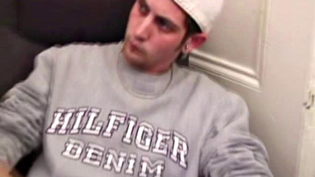 As a porn flick plays, young amateur Aaron Michaels strokes hard, pulls his cock out of his jeans, lets loose, and spills his nut on the bed.