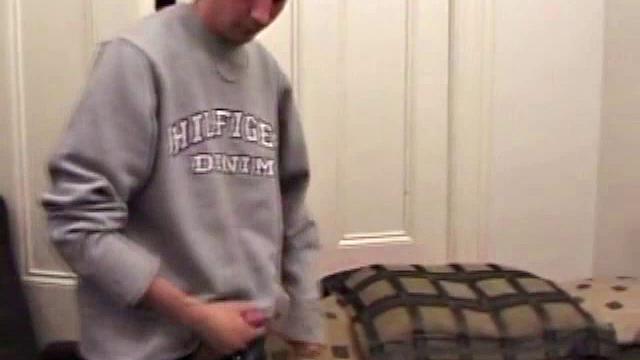 As a porn flick plays, young amateur Aaron Michaels strokes hard, pulls his cock out of his jeans, lets loose, and spills his nut on the bed.