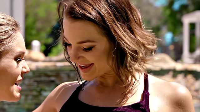 Tattooed lesbians take turns licking each other's wet bald pussy in outdoor pool