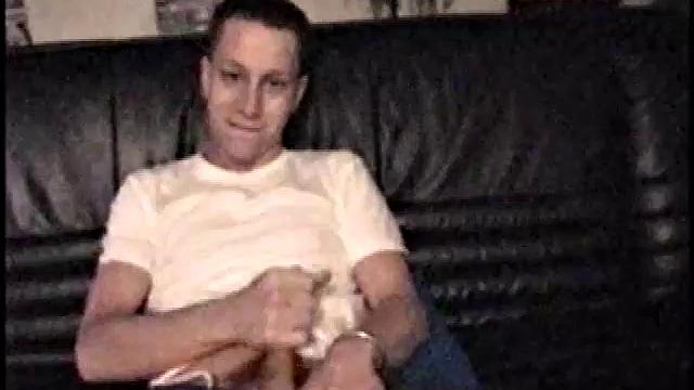 Kicking back on the sofa, Dominic mugs a bit for the camera, as he flips through some porn magazines for inspiration. He's pretty chatty, but gets quieter as he admires his hardening cock and strokes it.