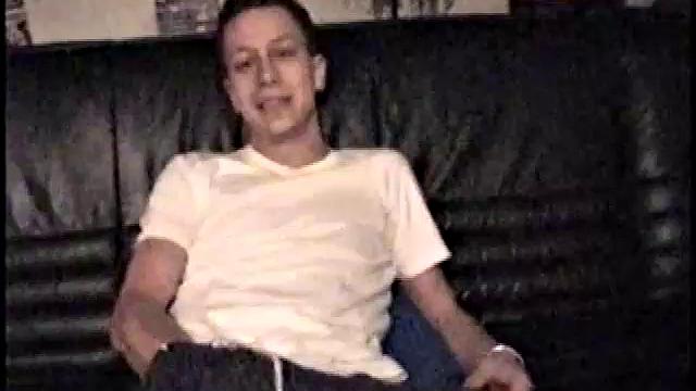 Kicking back on the sofa, Dominic mugs a bit for the camera, as he flips through some porn magazines for inspiration. He's pretty chatty, but gets quieter as he admires his hardening cock and strokes it.