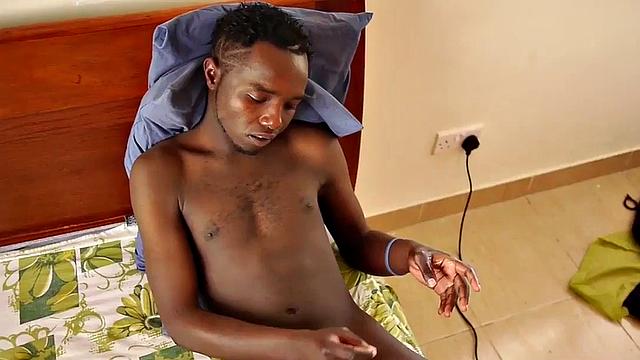 African amateur wanks uncut shaft while lying on bed