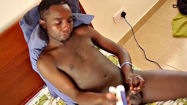 African amateur wanks uncut shaft while lying on bed