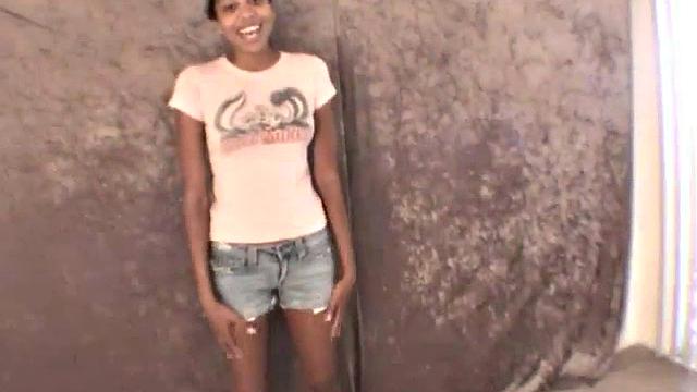 Slim amateur ebony teen fucks her pussy with a dildo in solo