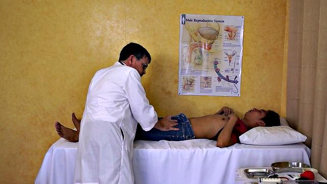 Mature doctor examines Asian enema and twink