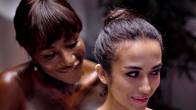 Sensual ethnic goddess scissoring ebony at massage