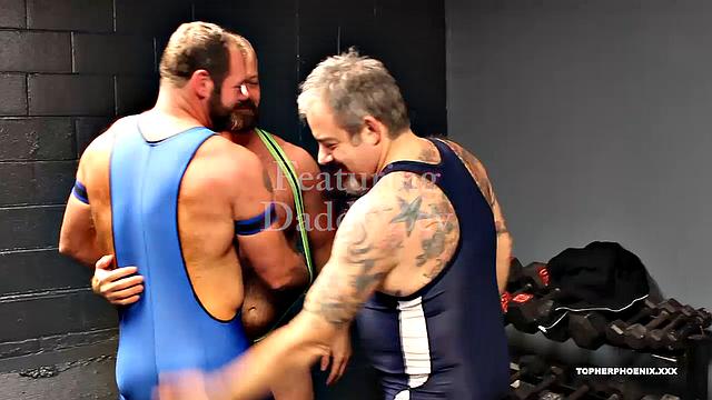 Topher Phoeniox and MuscleBull have had a rough workout, and they are ready to play. As they get started in the locker room, Coach Zev catches them, and wants to know what is going on. These two can't help but submit to the Coach.