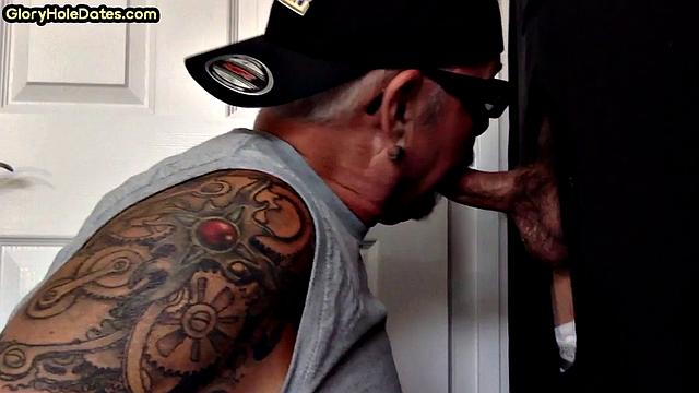 Gloryhole tattooed DILF sucks cock in private amateur BJ