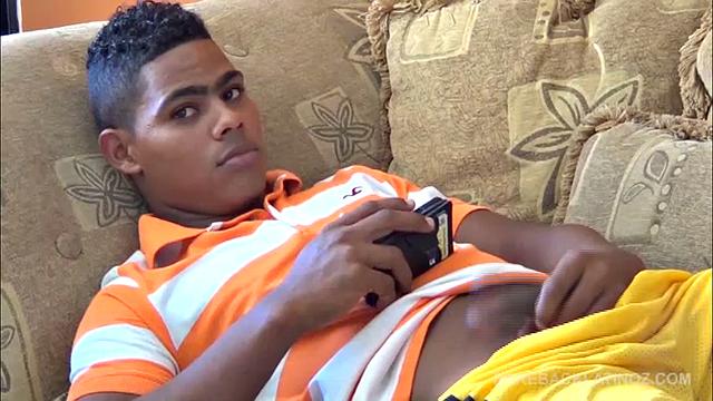 Santiago is on the sofa playing with his big uncut cock, when Ramon spots him from outside and invites himself in. He offers to help his friend out and goes down on Santiago, who is clearly enjoying the attention.