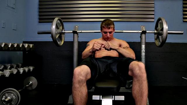 Shaved amateur solo masturbates on the gym bench