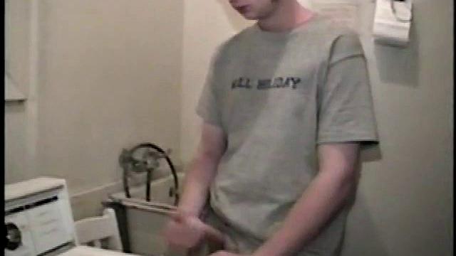 Boy-next-door spreads his new straight porn magazine on top of the washing machine and pulls his cock out of the fly.